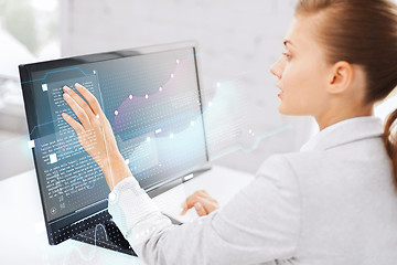 Image showing smiling businesswoman with touchscreen in office