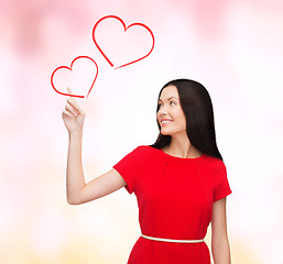 Image showing young woman in red dress pointing her finger