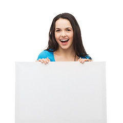 Image showing smiling young girl with blank white board