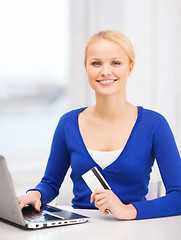 Image showing smiling woman with laptop computer and credit card