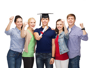 Image showing group of standing smiling students with diploma