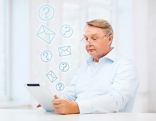 Image showing old man with tablet computer at home