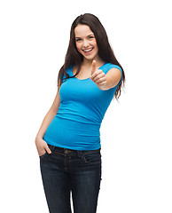 Image showing smiling girl in blue t-shirt showing thumbs up