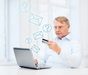 Image showing old man with laptop and credit card at home