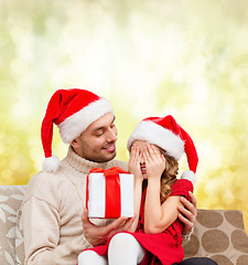 Image showing smiling daughter waiting for a present from father