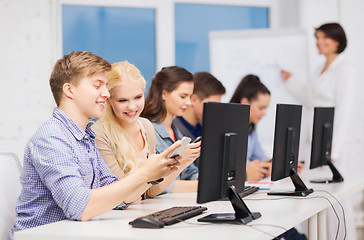 Image showing students with computer monitor and smartphones