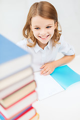 Image showing smiling little student girl with many books