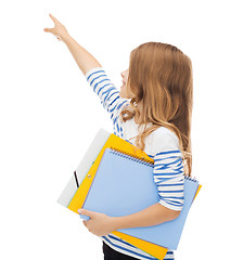 Image showing little student girl with notebooks pointing to