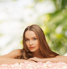 Image showing woman with rose petals and long hair