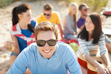 Image showing smiling man in sunglasses on the beach