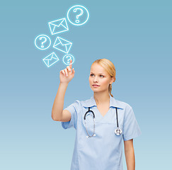 Image showing smiling doctor or nurse pointing to something