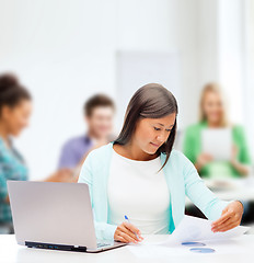 Image showing asian businesswoman with laptop and documents