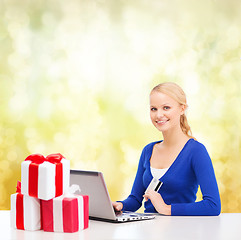 Image showing woman with gifts, laptop computer and credit card