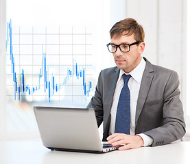 Image showing businessman with laptop computer and forex chart