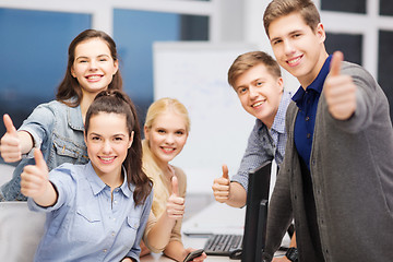 Image showing students with computer monitor and smartphones