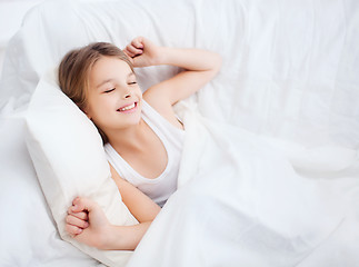 Image showing smiling girl child waking up in bed at home