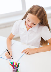 Image showing little student girl drawing at school