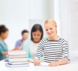 Image showing smiling woman studying in college