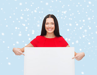 Image showing smiling young woman with blank white board