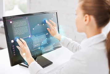 Image showing smiling businesswoman with touchscreen in office