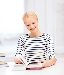 Image showing smiling woman studying in college