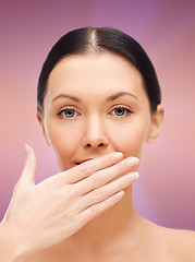 Image showing beautiful woman covering her mouth