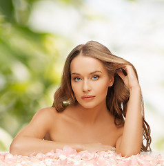 Image showing woman with rose petals and long hair