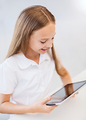 Image showing smiling girl with tablet pc at school