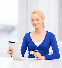 Image showing smiling woman with tablet pc and credit card