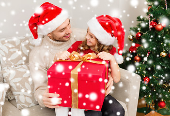 Image showing smiling father and daughter opening gift box