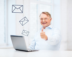 Image showing old man with laptop computer showing thumbs up