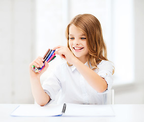 Image showing smiling girl choosing colorful felt-tip pen