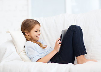 Image showing smiling girl with tablet computer at home