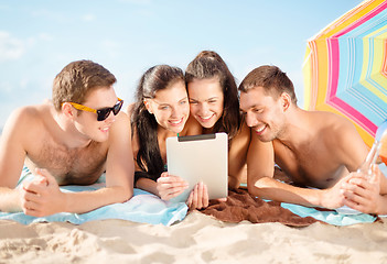 Image showing group of smiling people with tablet pc on beach