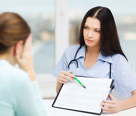 Image showing female doctor or nurse with patient