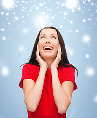 Image showing amazed laughing young woman in red dress