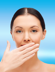 Image showing beautiful woman covering her mouth