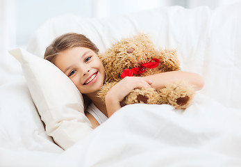 Image showing little girl with teddy bear sleeping at home
