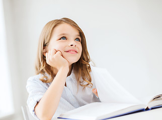 Image showing student girl writing in notebook at school