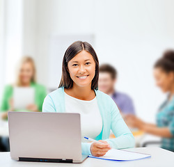 Image showing asian businesswoman with laptop and documents