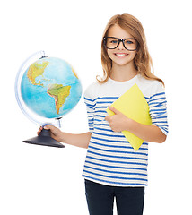 Image showing smiling child with globe, notebook and eyeglasses