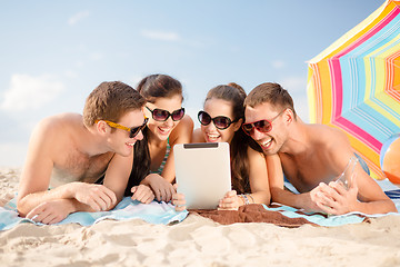 Image showing group of smiling people with tablet pc on beach