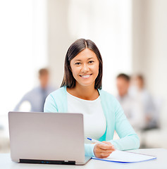 Image showing asian businesswoman with laptop and documents