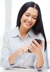 Image showing businesswoman or student with smartphone