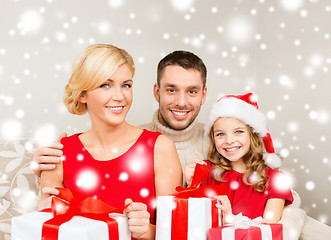 Image showing smiling family holding many gift boxes