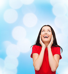 Image showing amazed laughing young woman in red dress