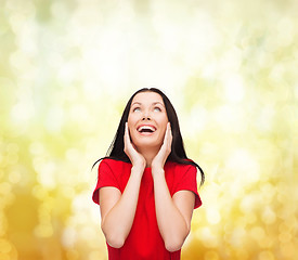Image showing amazed laughing young woman in red dress