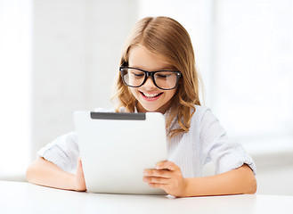 Image showing smiling girl in glasses with tablet pc at school