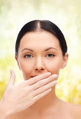 Image showing beautiful woman covering her mouth