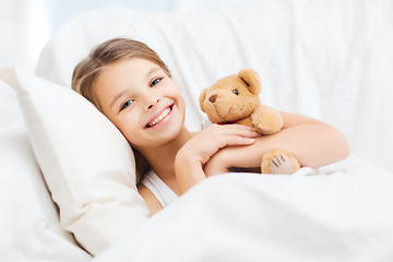 Image showing little girl with teddy bear sleeping at home